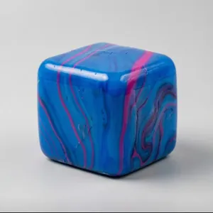 Macro detail of a square maltose squeeze toy with vibrant blue and pink marble flow patterns.