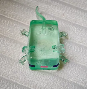 Detailed view of a green translucent voxel-style lizard squishy toy for stress relief