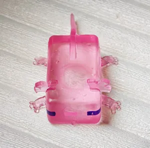 Close-up of pink translucent axolotl-shaped squeeze toy with purple eye markings.