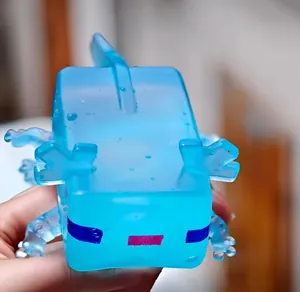 Close-up of translucent blue Minecraft-style axolotl squishy stress relief toy