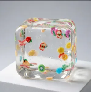 Transparent ice cube squishy toy with colorful fruit slices inside for stress relief