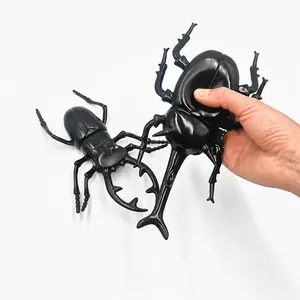 Large realistic plastic rhinoceros and stag beetle toy models with squeaky sound.