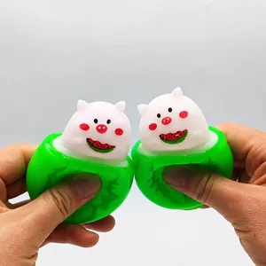 Stress relief squeeze toy featuring a cute pig popping out of a green watermelon cup