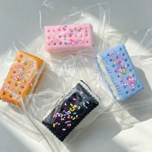 Macro view of colorful soda biscuit sandwich squishy toys in clear plastic bags.