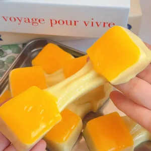 Macro view of yellow stretchy mochi stress relief toy showing realistic food play detail