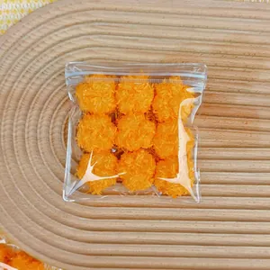 Close-up view of nine orange fuzzy coconut milk squishy toys in a clear plastic bag