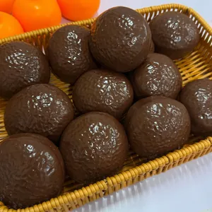 Close-up detail of textured chocolate-colored squishy balls with realistic snack appearance
