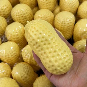 Large yellow peanut-shaped squishy stress relief toy with realistic textured surface