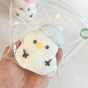 Detailed macro view of a cute snowman silicone squeeze toy in clear plastic packaging