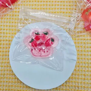 Close-up of pink strawberry cat paw squishy toy in clear packaging