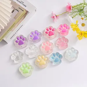 Translucent cat paw squishy stress relief toys in multiple colors on white surface