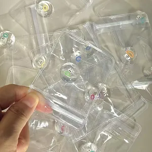 Detail showing mini cartoon monster squishy toys in clear plastic zip-lock packaging