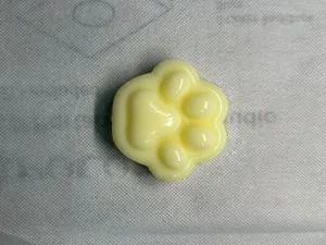 Close-up of a soft yellow cat paw squishy toy with slow rebound texture for stress relief.