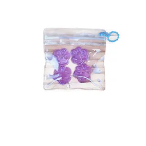 Mini Stressabbau Set: 4 lichtdurchlässige lila Katzenpfoten-Squishies in Tasche