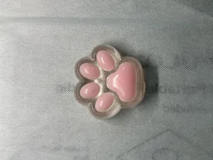 Close-up of cute pink cat paw squishy stress relief toy with soft slow rebound texture