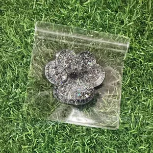 Macro view of holographic sequin cat paw squishy toy presented in a clear plastic bag