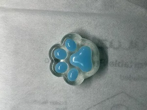 Macro top view of blue cat paw squishy stress relief toy with soft translucent texture