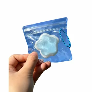 Blue star squishy toy bag charm in a transparent mini pouch with a blue bead chain