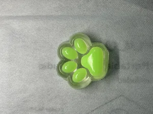 Close-up of a green cat paw squishy toy with soft slow rebound texture.