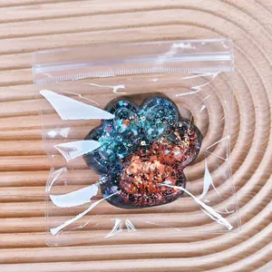 Glitter sequin cat paw squishy toy for stress relief in clear plastic packaging
