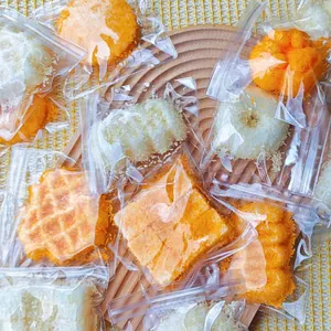 Variety of fried food squishy toys in individual clear plastic bags on a wooden tray