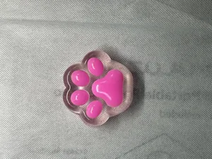 Close-up macro view of a pink cat paw shaped squishy toy with soft slow rebound texture