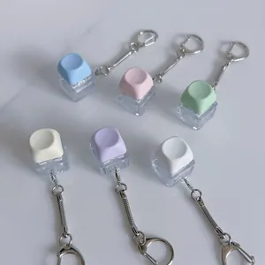 Six pastel colored mechanical switch fidget toy keychains on a clean white surface.
