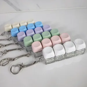 Close-up detail of macaron colored mechanical keyboard switch tester keychains.