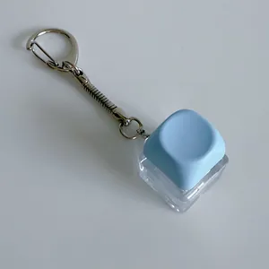 Close-up of a light blue mechanical switch fidget keychain on a white background