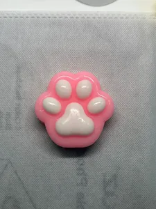 Close-up view of a cute pink and white cat paw shaped squishy slow rebound toy