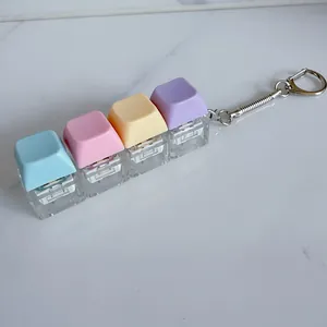 Close-up of macaron colored mechanical switch fidget keychain with four pastel keys