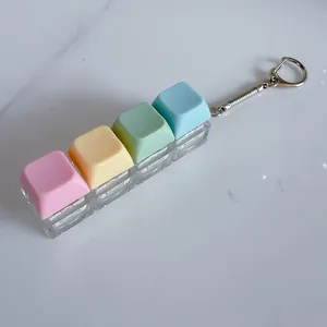 Close-up of colorful macaron mechanical keycap keychain fidget toy with silver ring