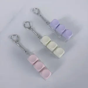 Macro detail of three mechanical keyboard switch tester fidget keychains in macaron colors