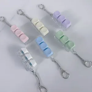 Macro view of 3-key mechanical switch tester fidget keychains in pastel macaron colors