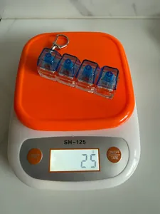 Detail view of a 4-key mechanical switch fidget keychain on a scale weighing 25g