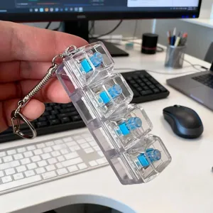 Premium clear 4-key mechanical switch fidget toy keychain displayed on a modern office desk