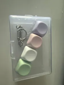 Fidget toy with 4 macaron mechanical keycaps and keychain in a clear protective box