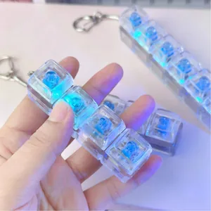 Close-up of glowing blue rose mechanical keyboard keycaps on transparent 4-key fidget toy