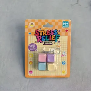 Detail view of four-key macaron colored stress relief button toy in retail packaging