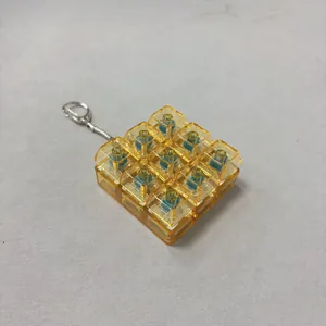 Detail of transparent amber 9-key mechanical switch fidget toy keychain with metal ring