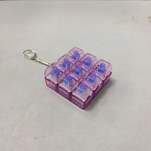 Close-up of 9-key mechanical switch fidget keychain with purple transparent caps.