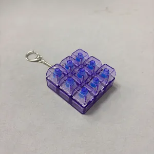 Detailed macro view of purple transparent 9-key mechanical switch fidget toy keychain.