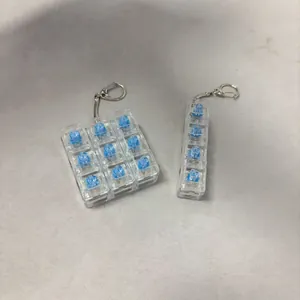 Detail view of 9-key and 4-key transparent mechanical switch tester decompression keychains