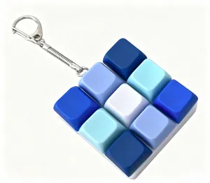 Detail view of 9-key mechanical keyboard fidget keychain in blue and white gradient