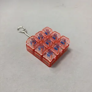 9-key mechanical switch fidget keychain in transparent red PC finish detail view.