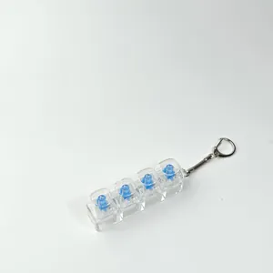 Close-up of a 4-key mechanical keyboard switch tester keychain with clear keycaps