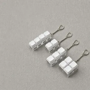 Close-up of white mechanical keycap keychains with diverse layout configurations