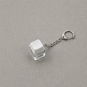 Detailed view of a high-transparency white mechanical keyboard keycap keychain