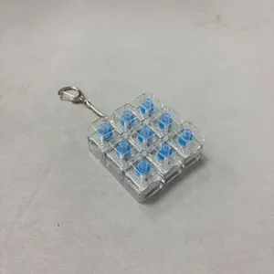 Detailed view of a 9-key mechanical switch fidget toy keychain for stress relief