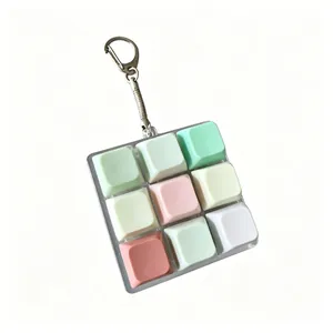 Close-up detail of a 9-key mechanical switch fidget toy keychain in pastel mixed colors